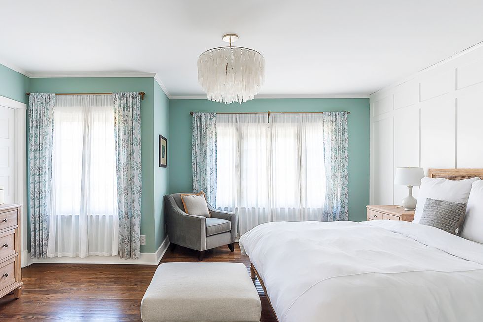 bright bedroom with a year round beach vibe blue accent wall, white linens victorian farmhouse home in pasadena, ca designers alice arterberry and barrett cooke of arterberry cooke architecture